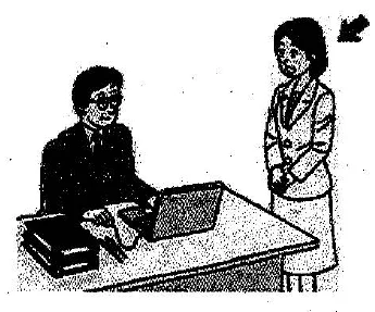 Scene: A man sitting at a desk with a laptop. A woman is standing behind him. An arrow points to the woman — from the JLPT N3 July 2013 listening section