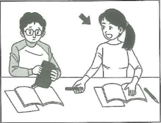 Scene: Two people at a desk with notebooks open. A boy with glasses watches as a girl with a ponytail (who has a gray arrow pointing to her) reaches for a pen — from the JLPT N5 2010–2011 listening section